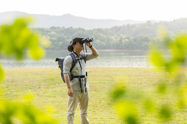 istock Wildlife traveler using binoculars to observe wild animals 2211582768