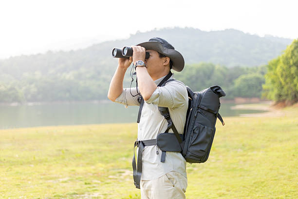 istock Wildlife traveler using binoculars to observe wild animals 2211582825