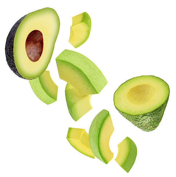 istock Levitating Avocado pieces isolated on white. Flying Avocado fruit slices. Avocado Explosion. Top view. Flat lay. Package design element 2211584942