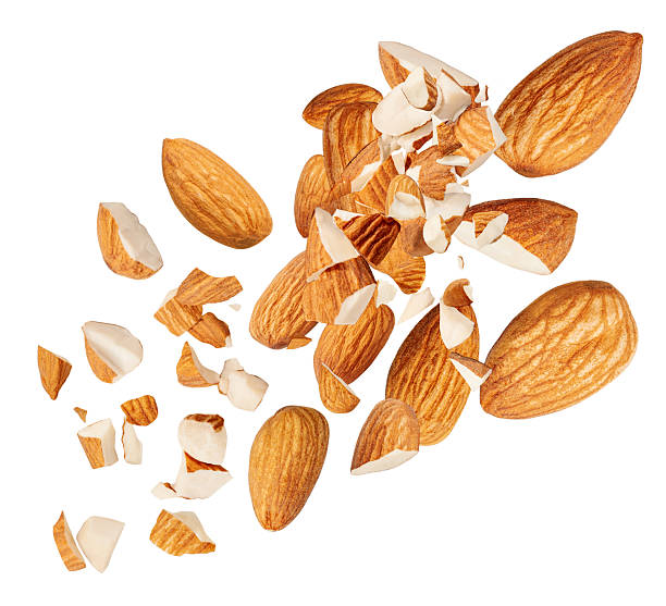 istock Fresh Almond nuts  levitating in air on white background. Isolated Falling crushed almonds nuts. Almonds is torn to pieces explosion with crumbs. 2211585148