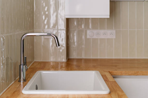 istock Modern kitchen interior featuring sleek faucet and minimalist design elements 2211586980