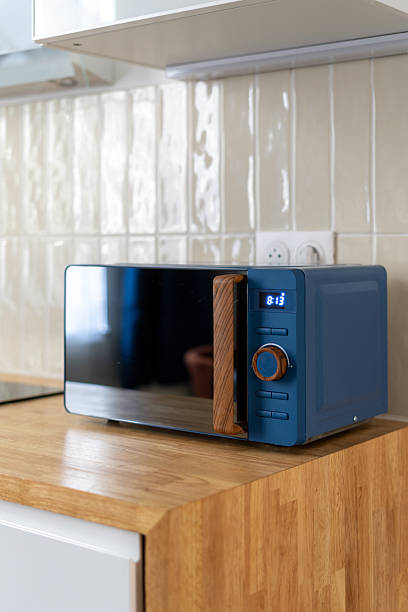 istock Modern kitchen with stylish microwave showcasing contemporary design elements 2211587078
