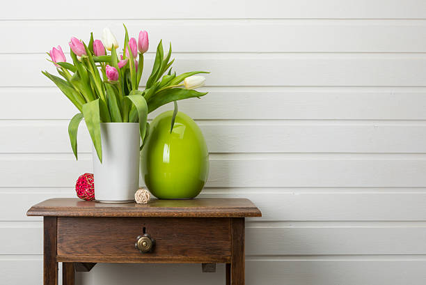 istock Tulips bouquet  in vase on side table 2211589789