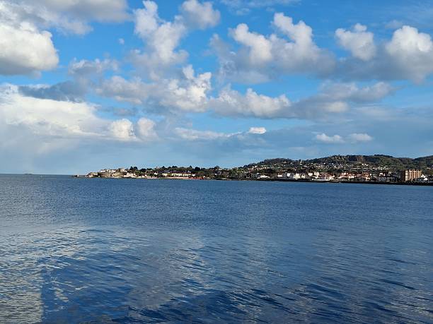 istock Scenic coastal town under a blue sky. 2211592396