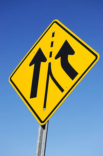 istock merge traffic sign against blue sky background 2211596004
