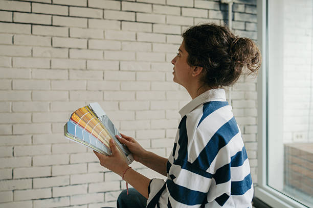 istock Choosing a wall paint from a colour swatch 2211596324