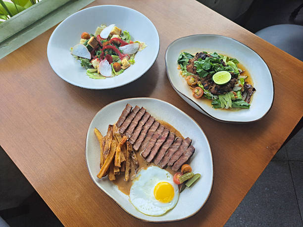 istock Oppa Steak & Egg With Meltique Striploin, Sunny Side Up Eggs And Handcut Fries. Chicken Vermicelli Salad With Lemongrass Chicken, Vegetables And Nouc Cham Dressing. Kyoto Greens Salad With Mesclun, Chuka Wakame, Crouton And Roasted Sesame Dressing. 2211596576