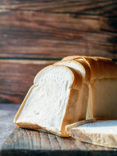 istock A stack of  white bread slices against Bread Sliced on Wooden Cutting Board 2211598220