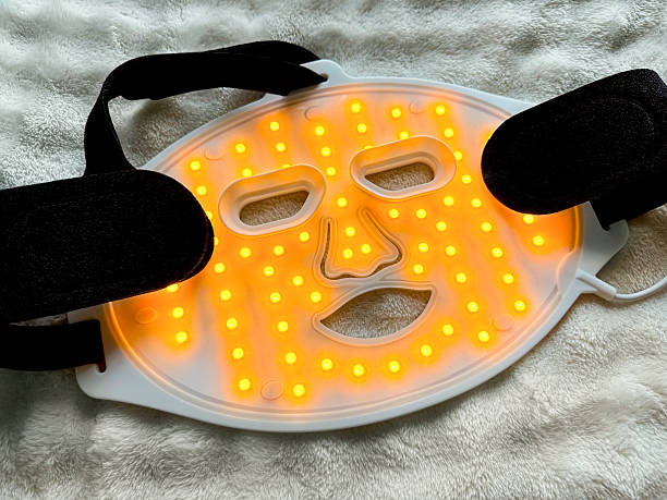 istock Led light therapy face mask on soft fabric, above view. Beauty treatment 2211598415