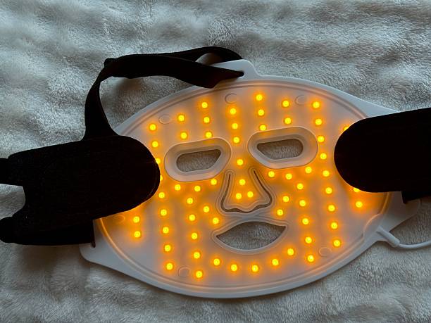 istock Led light therapy face mask on soft fabric, top view. Beauty treatment 2211598416