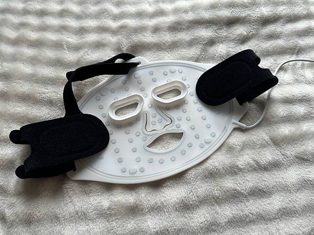 istock Led light therapy face mask on soft fabric, top view. Beauty treatment 2211598417