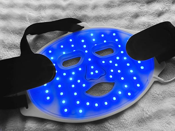 istock Led light therapy face mask on soft fabric, above view. Beauty treatment 2211598432