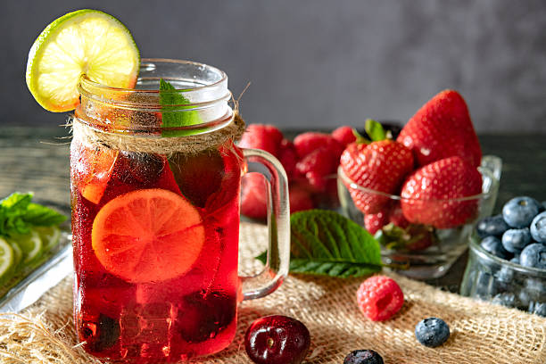 istock Refreshing berry cocktail with ice and lemon. Raspberry, lime, strawberry, blueberry, and leaves mint. Berry mojito close-up. 2211598646