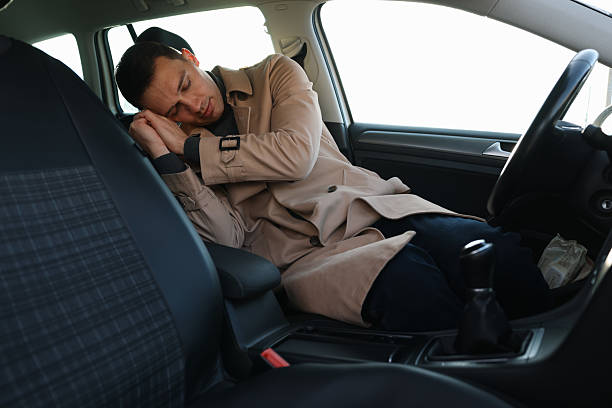 istock Tired driver sleeping in his modern car 2211598994