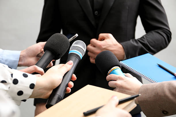 istock Group of journalists interviewing businessman on grey background, closeup 2211599185