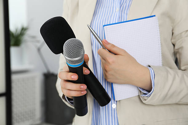 istock Journalist with microphones, notebook and pen indoors, closeup 2211599209