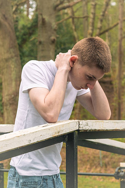 istock Depressed Teenage Boy Outside 2211599618