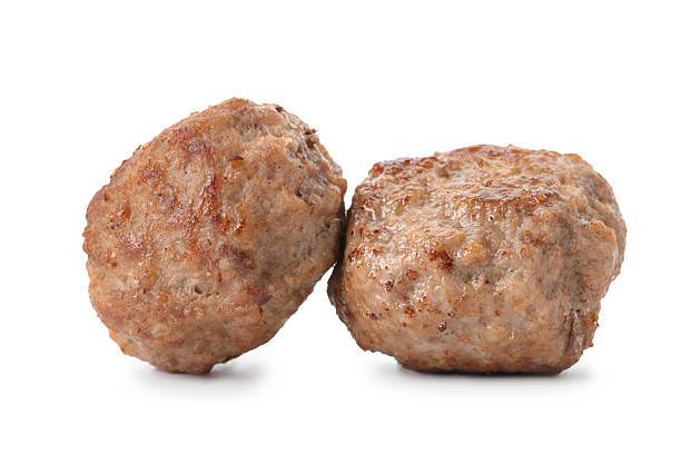 istock Two tasty cooked meatballs isolated on white 2211599813