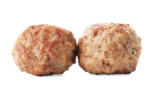 istock Two tasty cooked meatballs isolated on white 2211599834