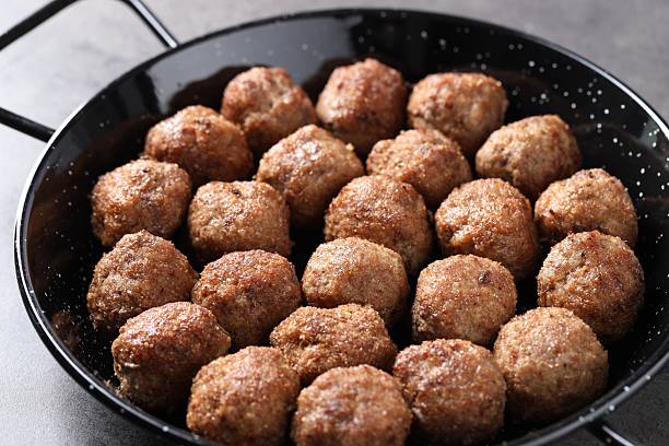 istock Tasty meatballs in baking dish on grey table, closeup 2211599859