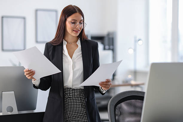 istock Portrait of banker with documents in office 2211602002
