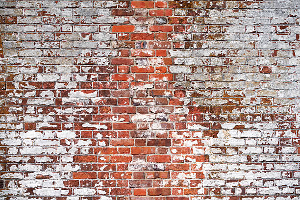 istock Old, vintage shabby brick wall with lime paint. Background for designers. 2211604277