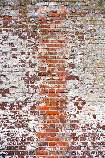 istock Old, vintage shabby brick wall with lime paint. Background for designers. 2211604349