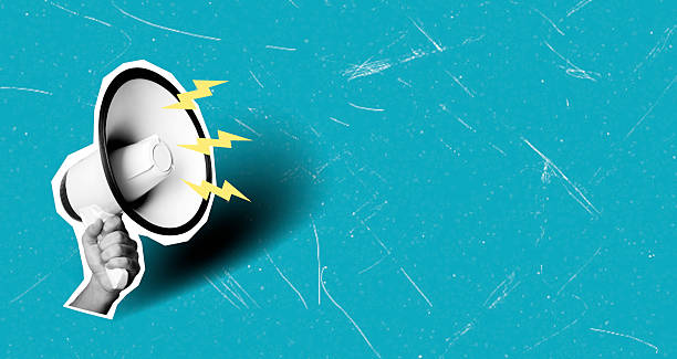 istock Modern art collage featuring a hand with a megaphone on a blue background with space copy and lightning. 2211614152
