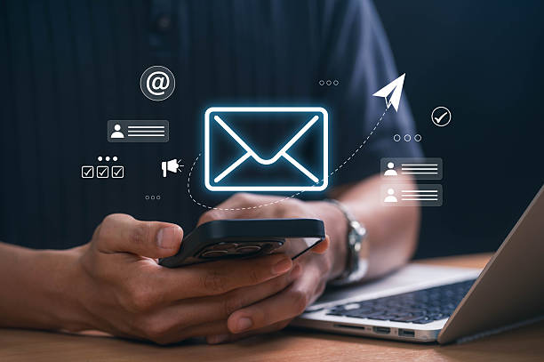 istock Digital marketer using email marketing tools on laptop and smartphone, sending newsletters and analyzing campaign performance to engage subscribers and grow business through personalized content 2211615411