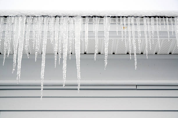 istock icicle hanging on house roof 2211618371
