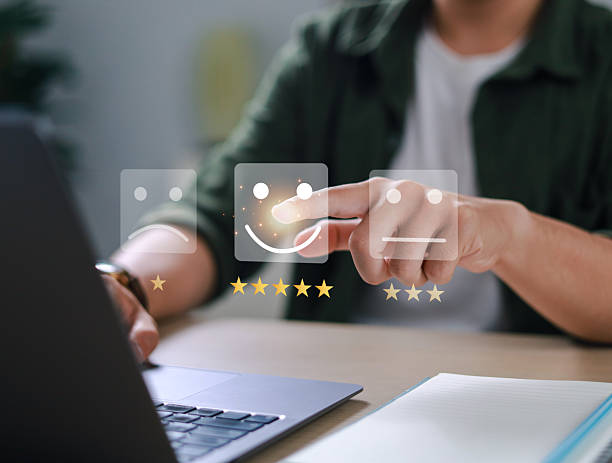 istock Businessman uses smartphone to provide five-star feedback for customer satisfaction survey, increasing company rating and improving service quality. 2211619103