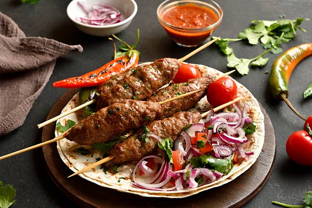 istock Grilled lula kebab with fresh vegetables on flat bread 2211621516