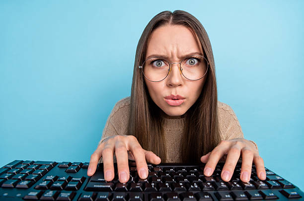 istock Portrait of attractive focused tense funny girl typing playing strategy game solving problem isolated over bright blue color background 2211626518