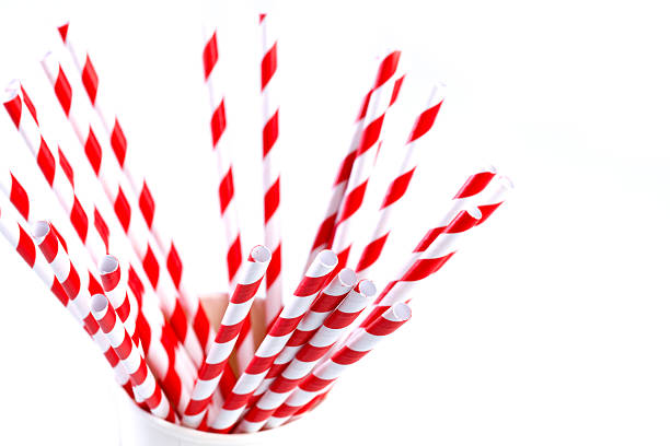 istock Red and white paper straws in cup on white background 2211626734