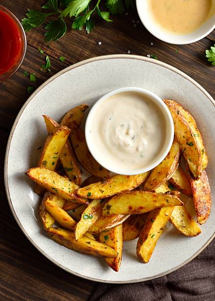 istock Potato wedges with dipping sauce 2211628765