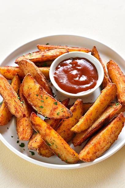 istock Oven baked potato wedges with sauce 2211628768