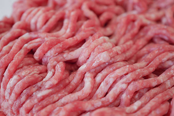 This vibrant image showcases a detailed view of minced beef ready to be prepared into delicious dishes, highlighting its natural color and rich composition