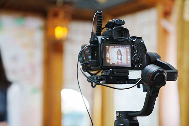 istock A professional camcorder with a blurred image on the screen. 2211630361