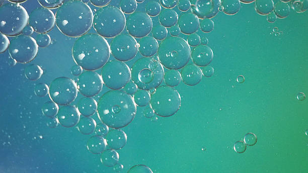 istock Bubbles blur abstract in green and dark blue background 2211633792