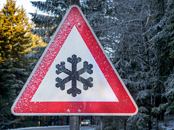 istock iced winter warning traffic sign on road 2211634361