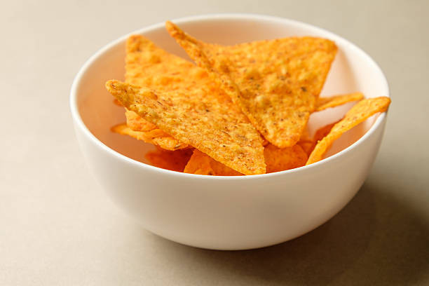 istock Crunchy snack experience with vibrant nacho chips in a cozy setting 2211637504