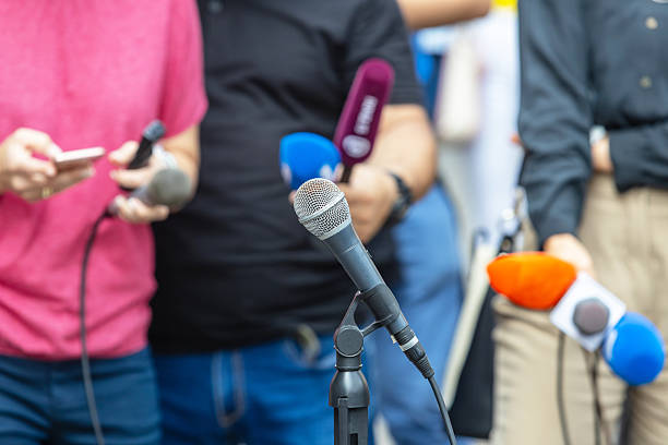 istock Journalists with microphones at press conference or media event 2211639026
