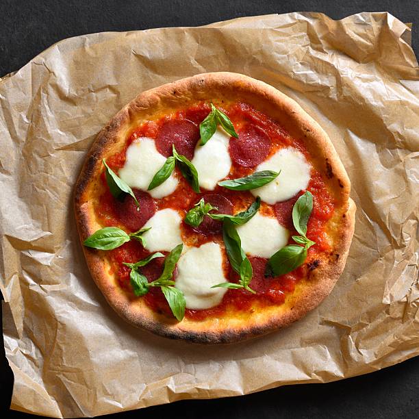 istock Pizza with mozzarella, pepperoni, tomato sauce and basil 2211641221