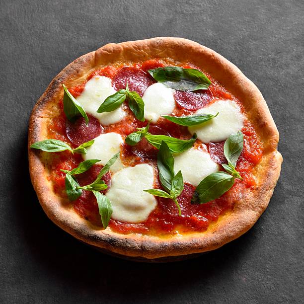 istock Pizza with mozzarella, pepperoni, tomato sauce and basil 2211641225