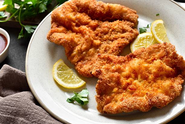 istock Schnitzel with lemon and leaves of parsley 2211641638