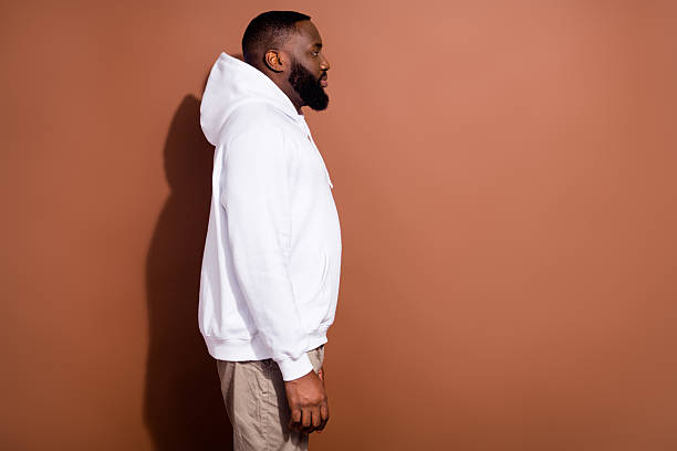 istock Photo of serious confident guy dressed white sweatshirt looking empty space isolated brown color background 2211643215