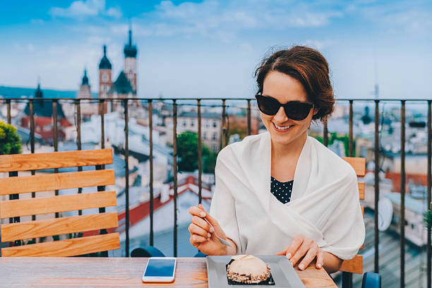 istock Woman in restaurant eating dessert 2211645479