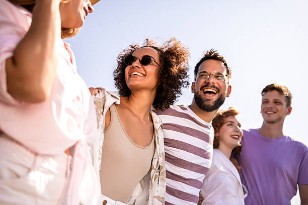istock Group of young friends walking on the beach 2211645757