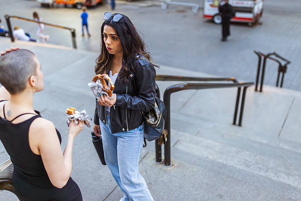 istock Urban Conversation: Friends Chatting on City Steps 2211647542