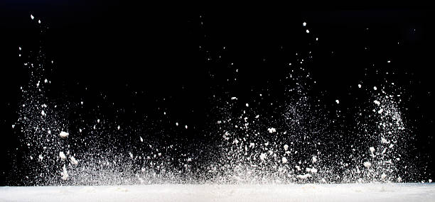 istock Milk splashes upward dramatically against a black background 2211648228